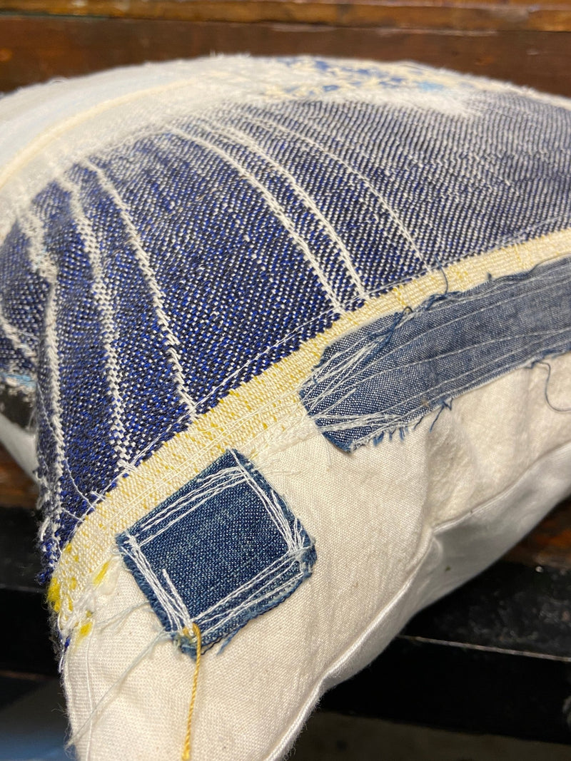 Handmade reworked cushion in salvage linen, denim, fabrics and treads. By Lost and Found Projects and JMR Design by Barewall