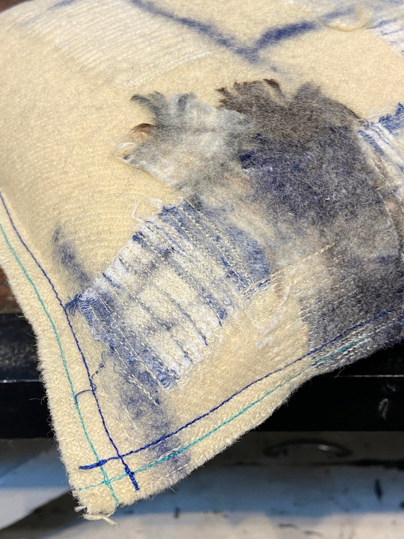 Handmade reworked square cushion in vintage blanket and salvage treads (blue). By Lost and Found Projects and JMR Design by Barewall